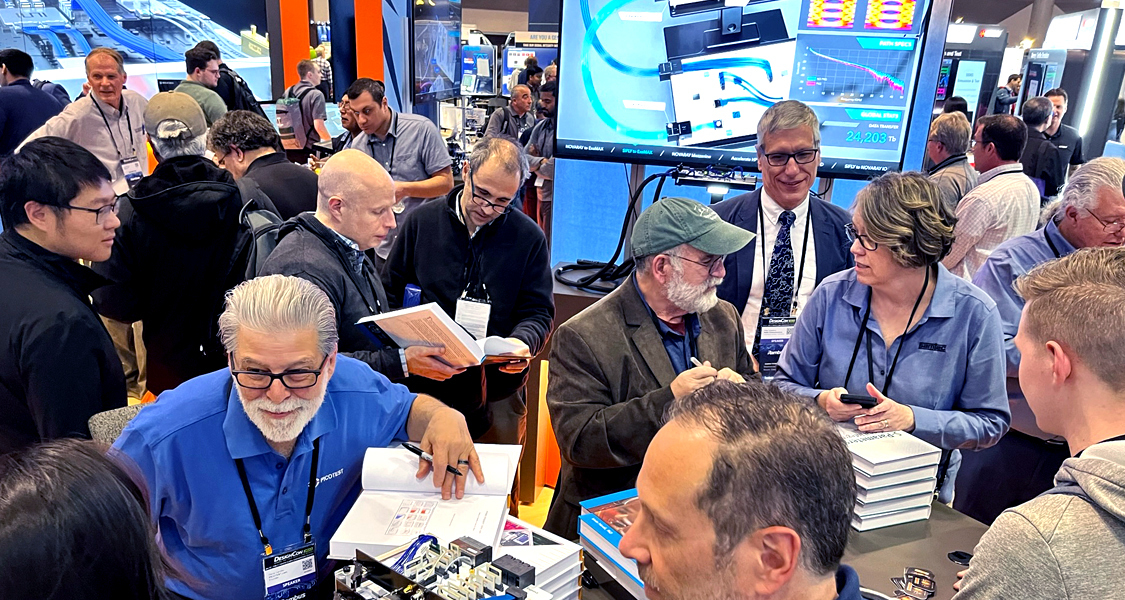Several people interacting at a Samtec conference booth